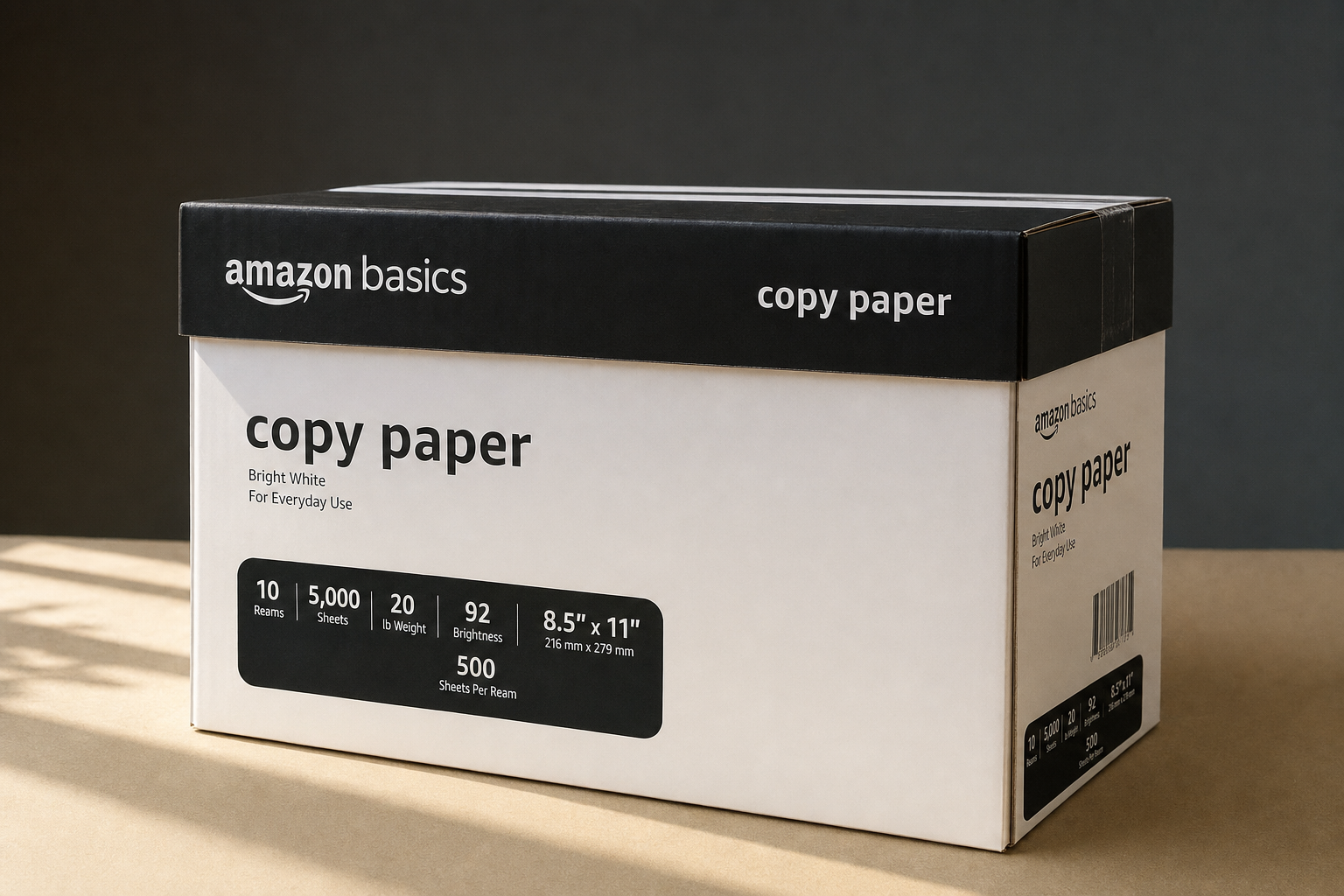 Sealed Amazon Basics 10-ream copy paper case on a neutral surface with natural lighting