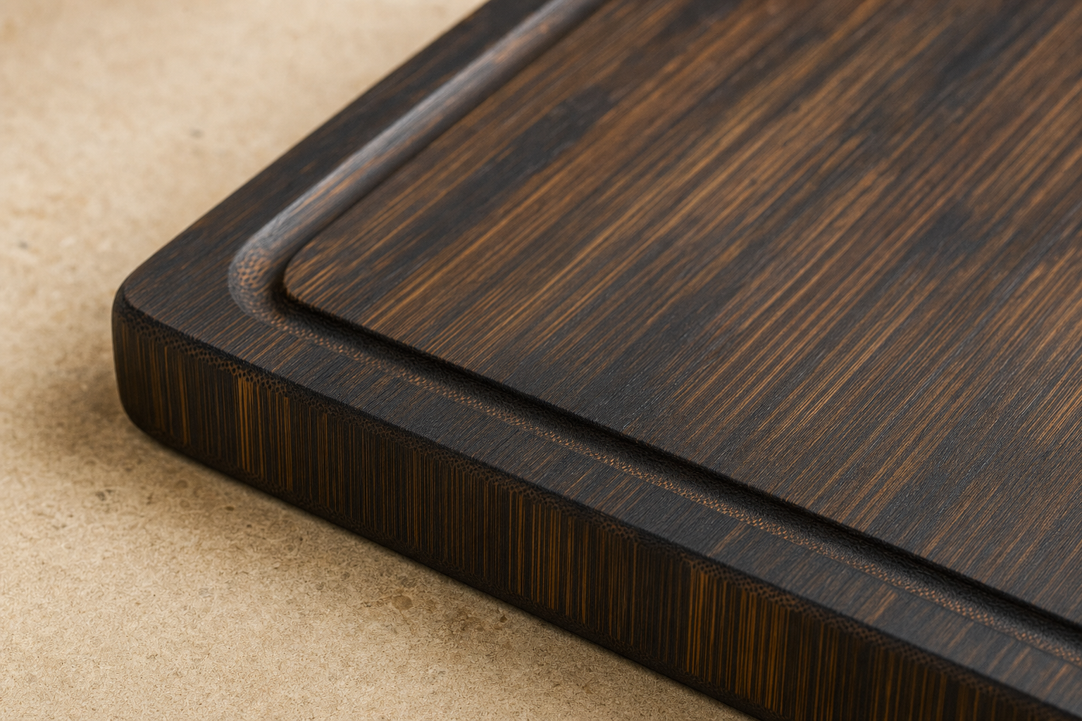 Close-up of deep-carbonized bamboo cutting board surface showing grain texture and juice groove