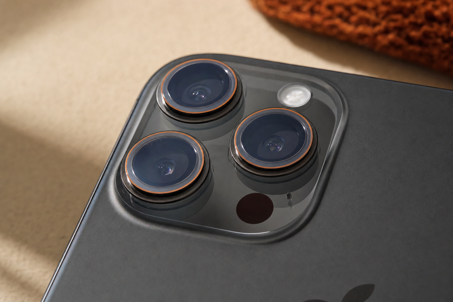 Camera lens protector rings placed over the iPhone 15 Pro Max triple-camera module