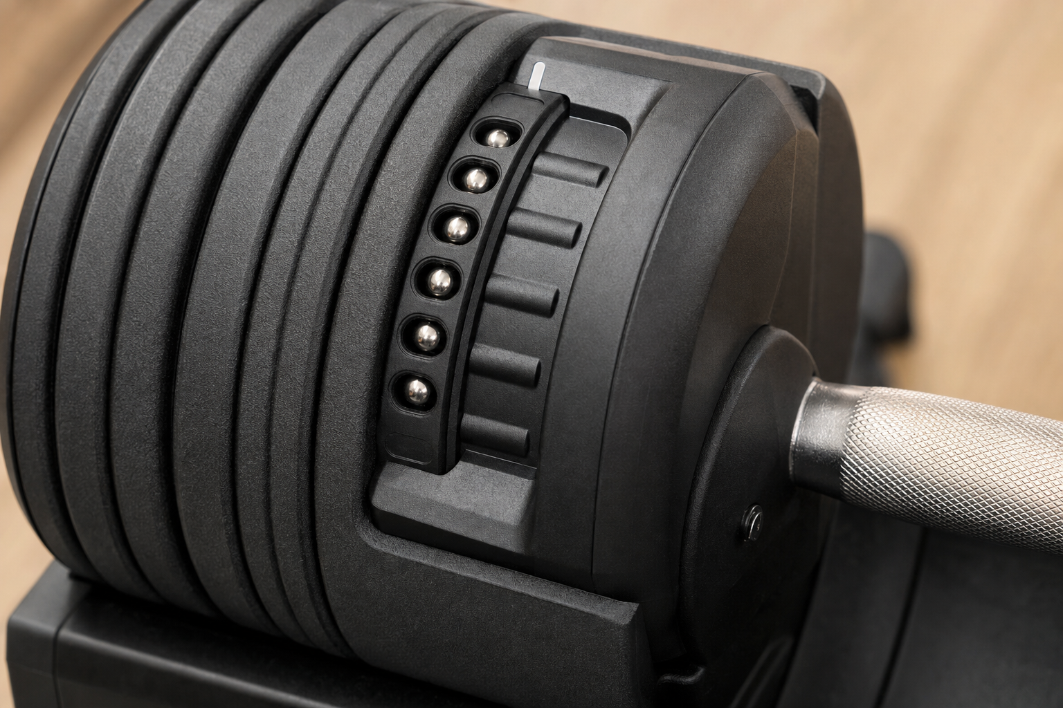 Close-up of the adjustment mechanism on an adjustable dumbbell.